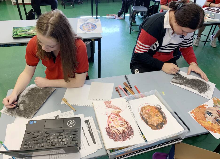 LEARNING: Oberon High School visual arts students Sophie Redman and Kelsey Sheehy. Students have been completing a unit on portraiture.