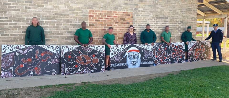 PRIDE: Aboriginal inmates at Oberon Correctional Centre with their artwork.