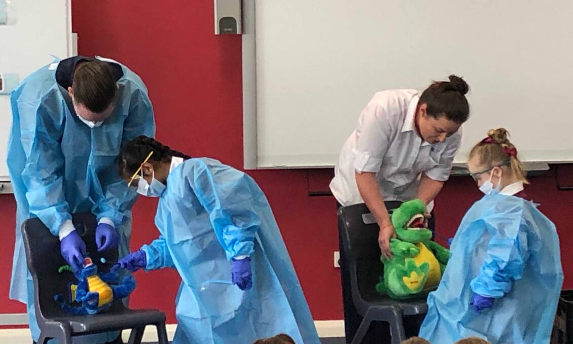 HANDS ON: St Joseph's School students working with Rhiannon and Mitch from the Dental Clinic at Bathurst Health Service.