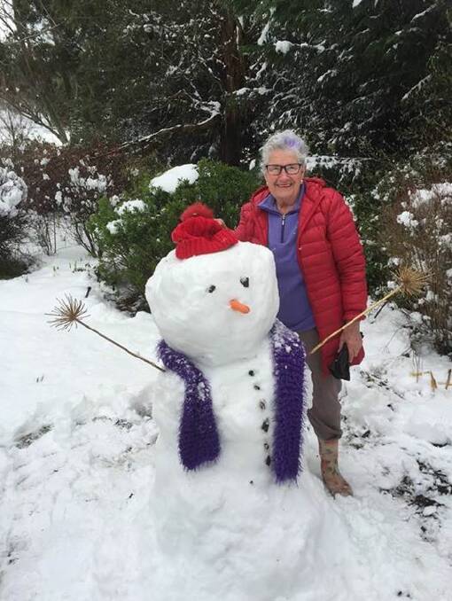 EXCITED: Brenda Lyon with her snowman in her garden at Brydie Park. Her garden will be open in three weeks for a Rotary fundraiser.