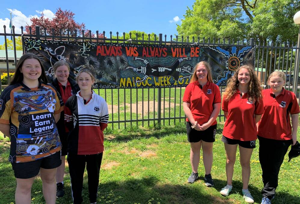 MEANING: Oberon High School students Kelsey Sheehy, Molly Deaton, Elsa Schrader, Porchae Mobbs, Micah Leihn and Allison Bennett with the NAIDOC Week banner.