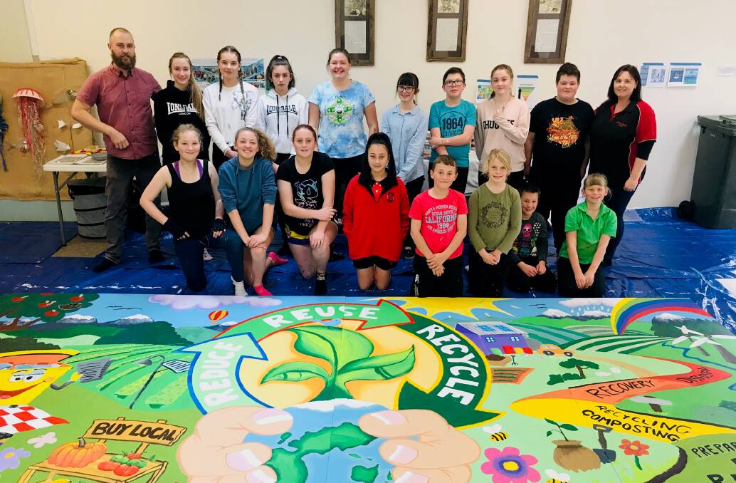 WORKERS: Oberon Public School students and teachers working on the Waste To Art regional mural.