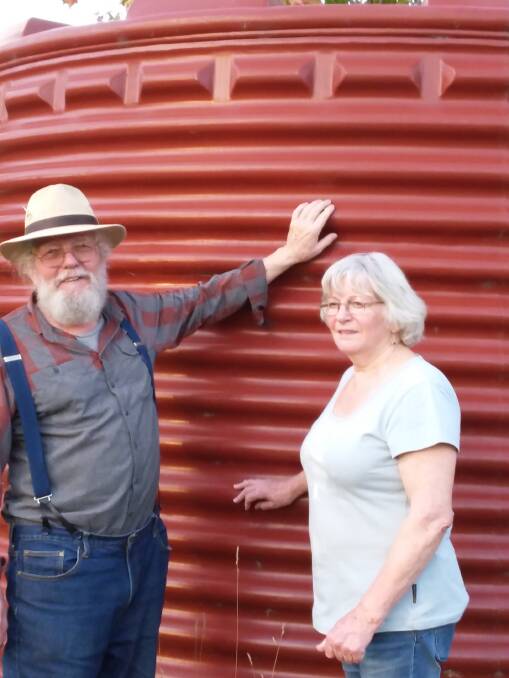 CONCERNS: Fred and Rina Janssen, standing against water tanks on their property in the Titania Estate, are worried about contaminated groundwater.
