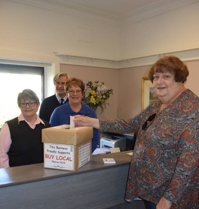 SMILE: Helen Lowe, Wayne Marvin and Cecily Fitzpatrick with HE Lowe and Company's customer Sandra Jackson.