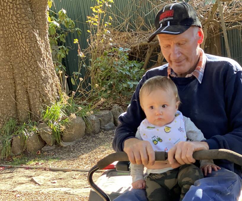 FAMILY MAN: Bruce Armstrong on the mower with his great-grandson, Chace.