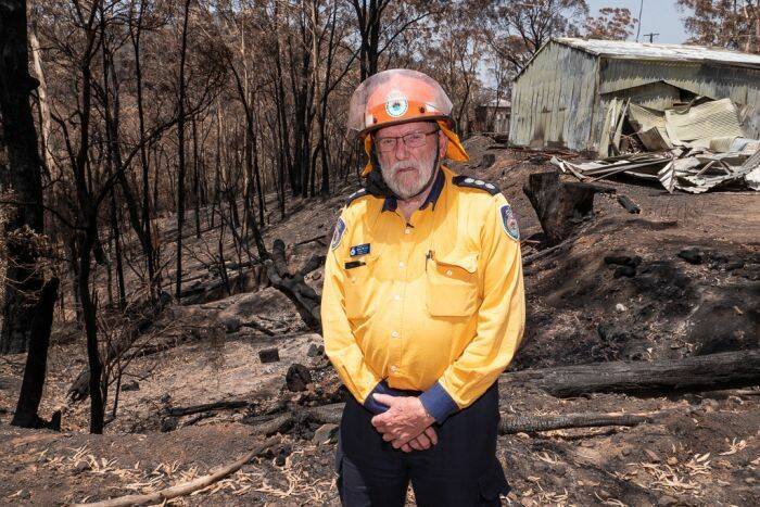 DEVASTATED: Jenolan Caves Rural Fire Service member Barry Richard in front of the brigade's burnt-out rural fire headquarters.