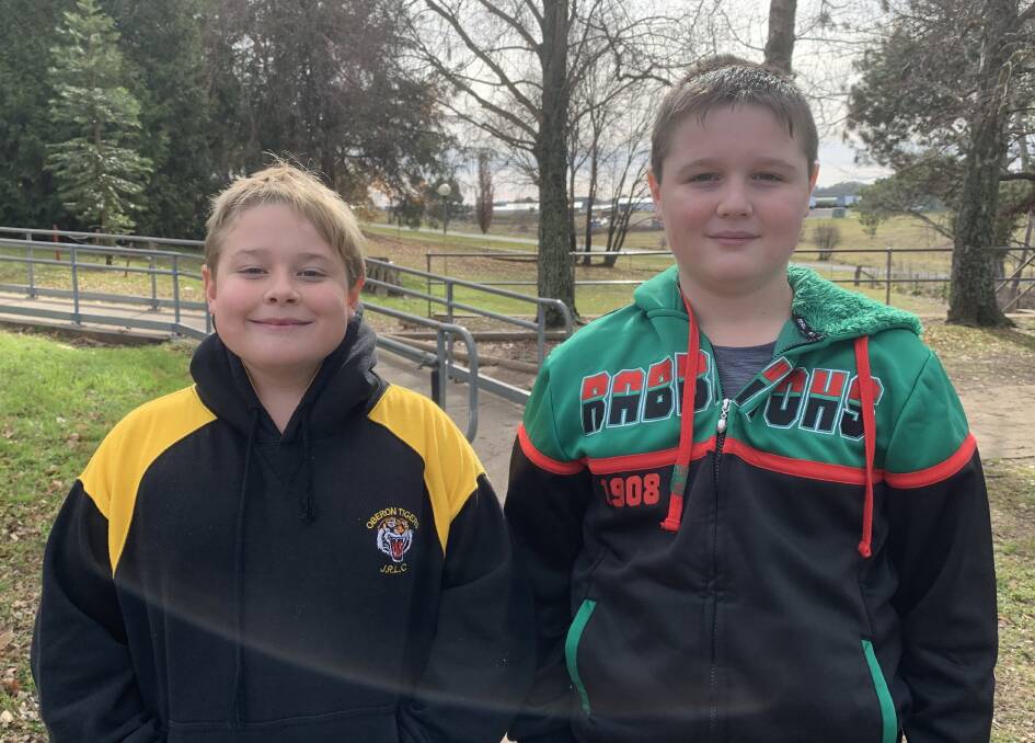 HAPPY: Oberon Public School students Oliver and Nathan show their footy colours in recognition of their efforts in demonstrating the 3Rs.