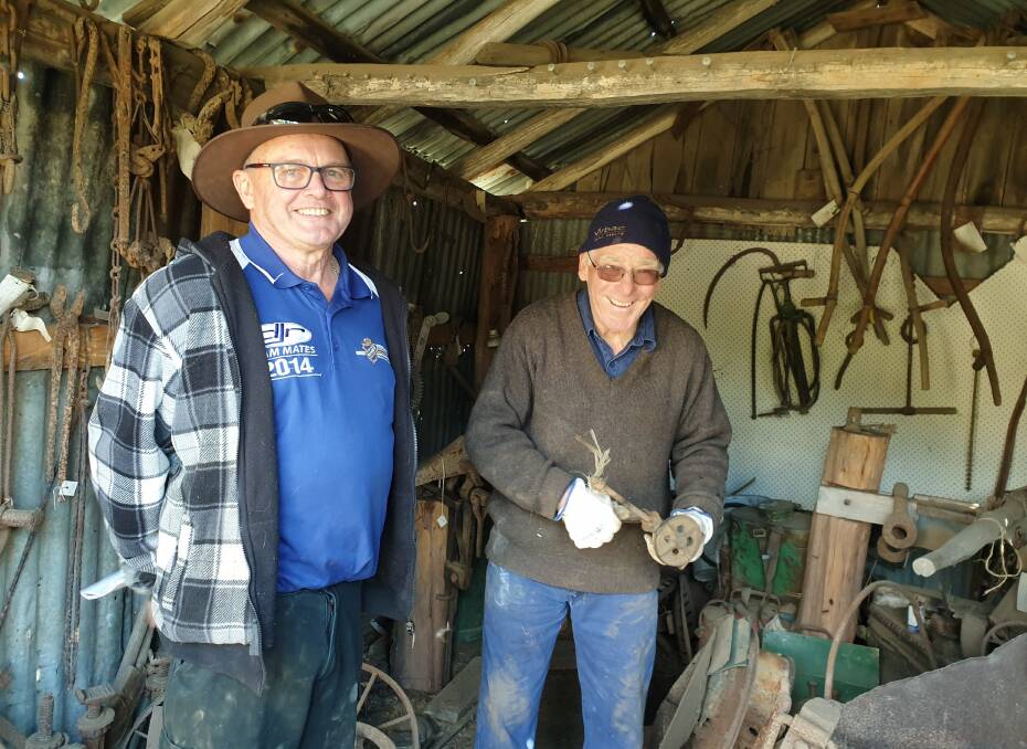 BUSY: Oberon and District Museum members Phil Harper and Tim Arnison cataloguing tools in the blacksmith's shed.