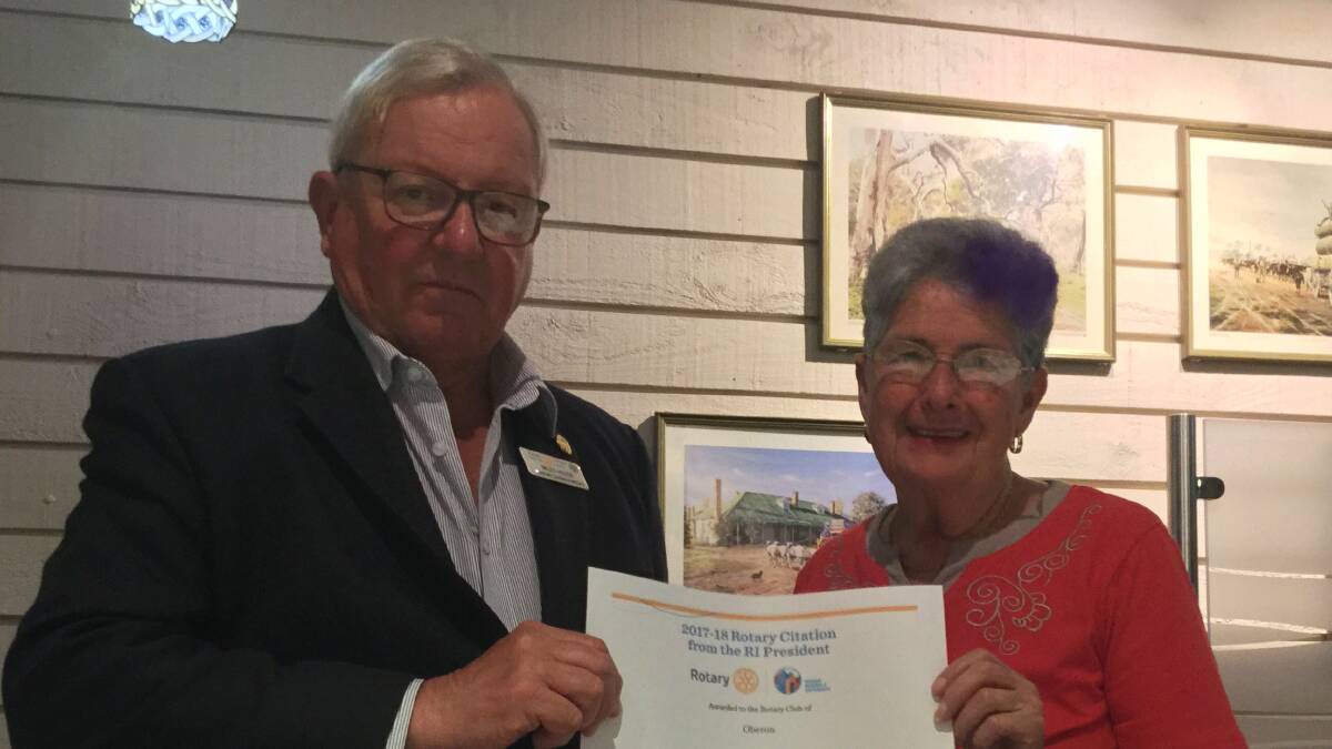 HONOUR: Miles Hedge presents Rotary Club of Oberon past president Brenda Lyon with a citation recognising the club's achievements.