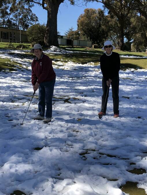 KEEN: Glennie McGrath with new women's golf club member Denise Brown teeing off in the snow for a round of social golf.