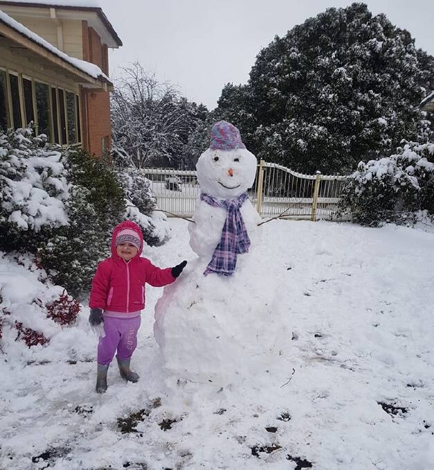 WHITE OUT: The white and fluffy snow was perfect for the many snowmen around the town. Tara Love posted this picture of her daughter with a giant snowman.