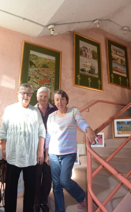 END OF AN ERA: Cobweb Craft Shop volunteers Ros Brown, Flo Spence and Lyndle Hawks close the doors for the final time.