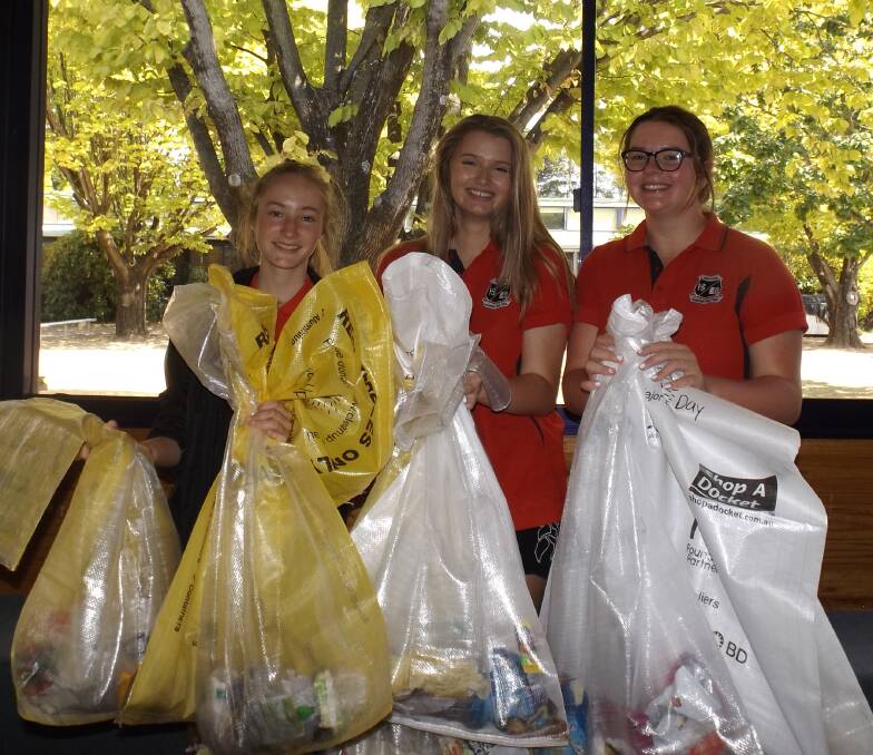 WORKERS: Jessie Blinco, Ashleigh Hopson and Rebecca Stewart with some of the rubbish collected on Clean Up Australia Day at Oberon High School.