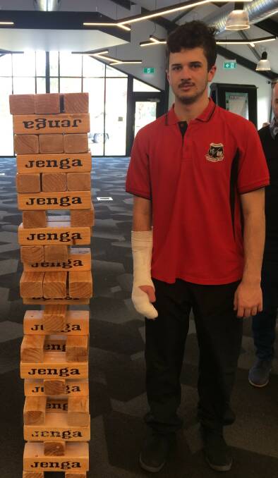 ENGINEERING: Oberon High School's Nathan is only just taller than the Jenga puzzle at Charles Sturt University.