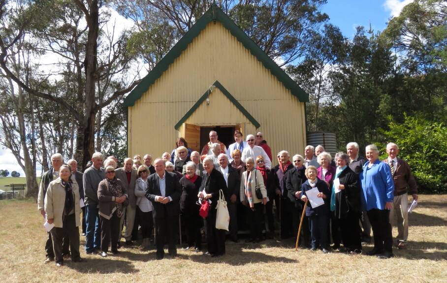 OPEN FOR WORSHIP: Community members with Reverend Andrew Sempell at the doors to St Aidan's Village Church, Black Springs at the re-hallowing ceremony held last Sunday.
