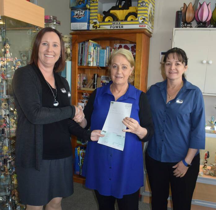 SMILES: Oberon Council staff members Vicki McKinnon and Michelle Neilson present a cheque to Oberon Can Assist  committee member Katie Maher.