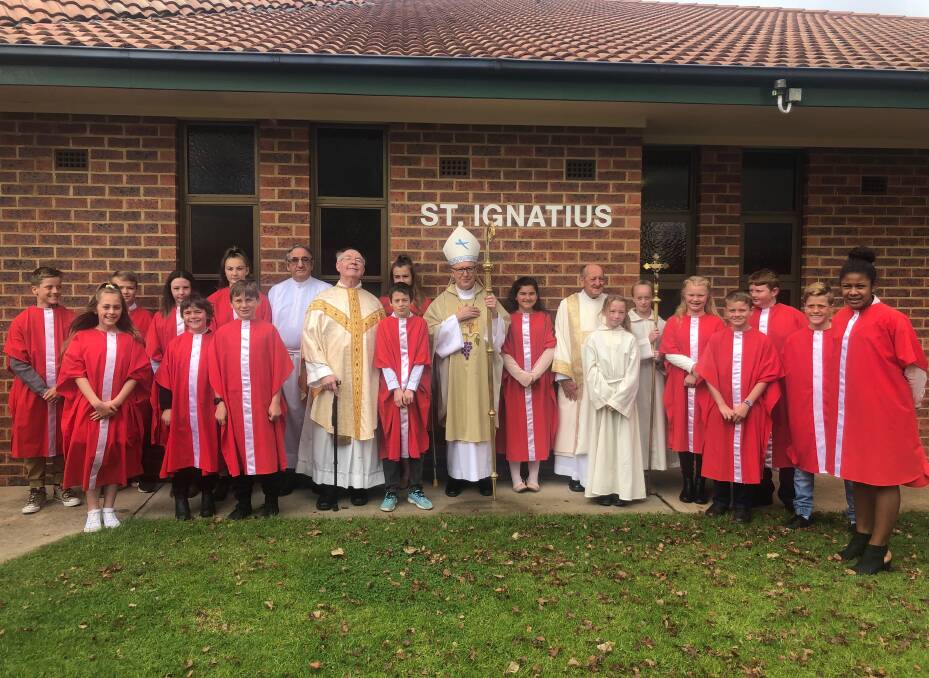 CONGRATULATIONS: Bishop Michael McKenna and Father Filby officiated at the St Ignatius' Parish confirmation celebration.