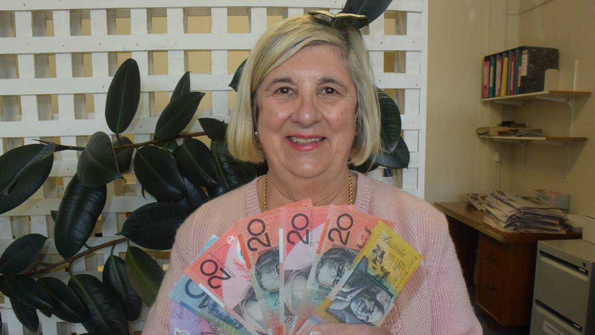 WINNER: Oberon Hospital Auxiliary president Annabelle Gilbert collects after the auxiliary's win in last week's Oberon Review Melbourne Cup Sweep.