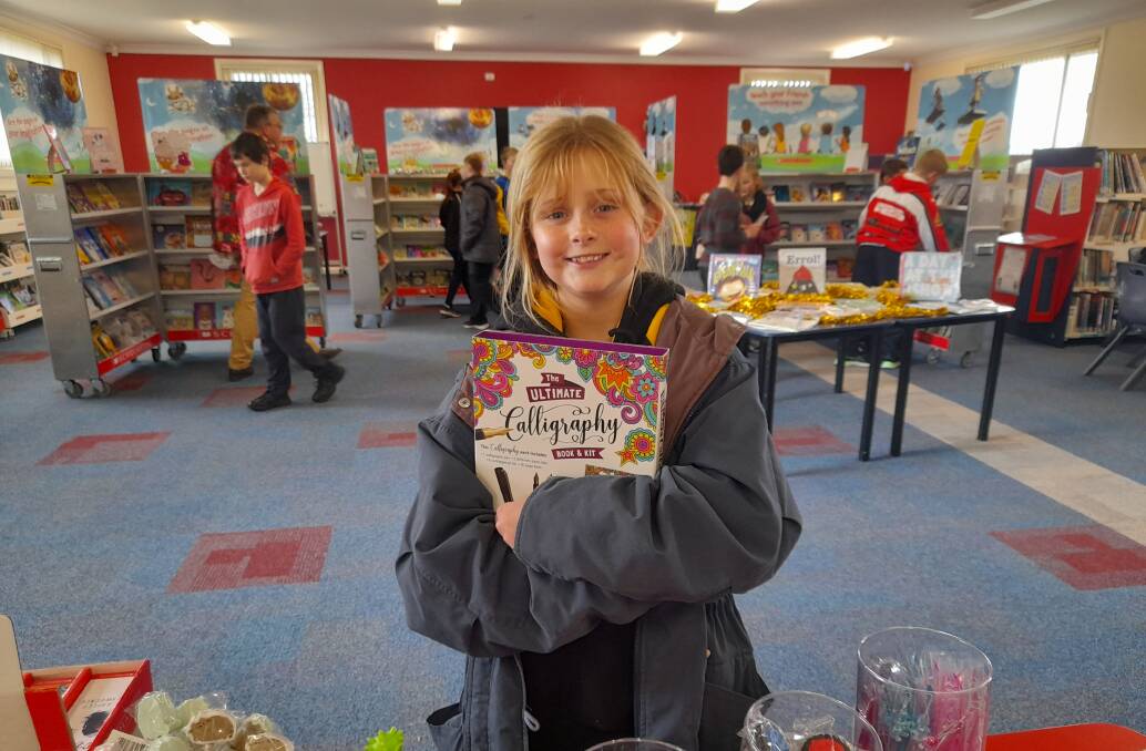 BOOK IT IN: St Joseph's student Grace Yeo with her Book Fair purchase.