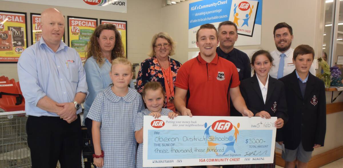 DONATIONS: Ian Mawhood from Mawhood Brothers Supa IGA presents a cheque to local schools from the IGA Community Chest funds.