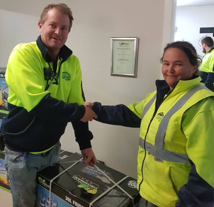 WELL DONE: Australian United Timber's production manager Anthony Francis congratulates loader driver Tara Booth on her contribution to the company.