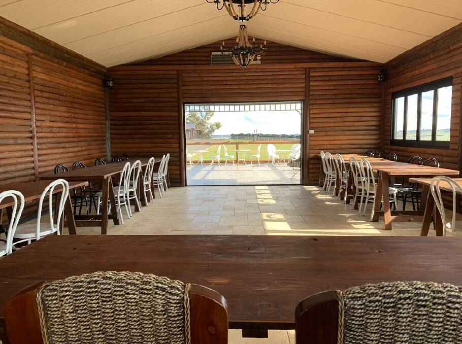 OPTIONS: The log barn with an alfresco dining can accommodate up to 54 guests. The couple purchased the property in 1997.