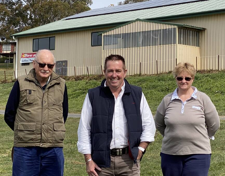 GOING SOLAR: Member for Bathurst Paul Toole, centre, with John Brotchie and Lynn Butterfield from the Oberon Show Society and the new solar panels.