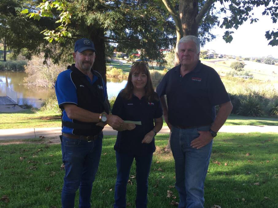 GOOD CAUSE: Oberon Fishing Club members Russell Bailey and Peter Brennan handing over a cheque to Oberon Can Assist president Brenda Armstrong.