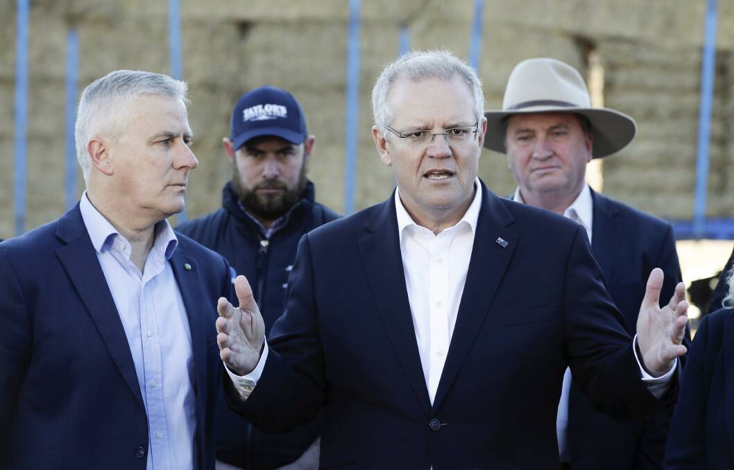 Don't worry, be happy: Deputy Prime Minister and Nationals leader Michael McCormack (left) and Prime Minister Scott Morrison have downplayed the IPCC report on the threats of climate change. Photo: Alex Ellinghausen