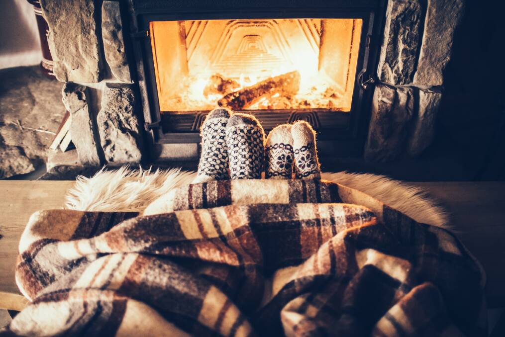 Toasty warm: There is nothing better during the colder months than being curled up in front of a nice wood fire. Photo: Shutterstock.