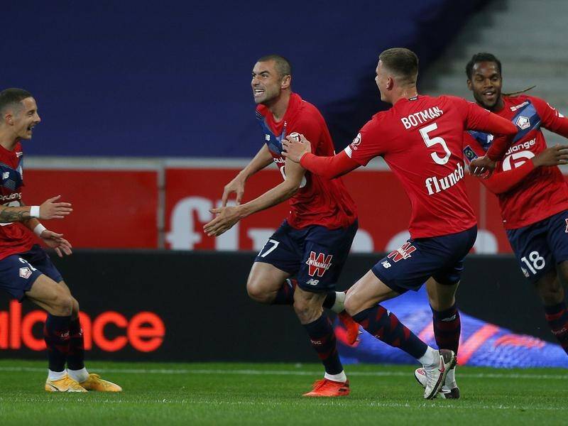 Lille's Burak Yilmaz (2 -l) celebrates after scoring against Lens in their 4-0 win.
