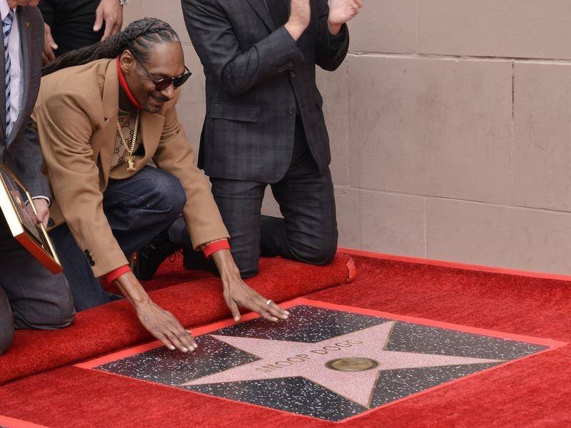Rapper Snoop Dogg has been honoured with a star on The Hollywood Walk Of Fame.