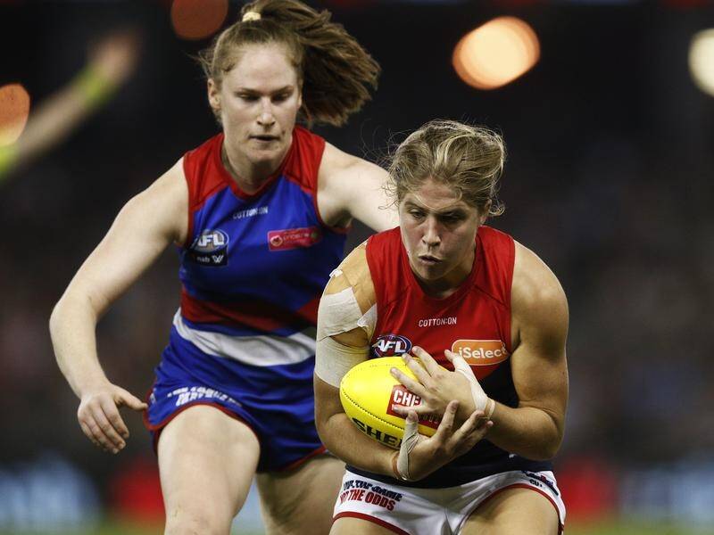 Melbourne's Katherine Smith (r) will miss the entire AFLW season with an ACL injury from training.