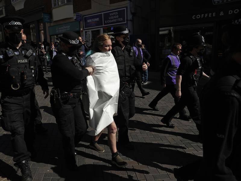 Police have taken away a topless protester who shouted "save the planet" outside Windsor Castle.