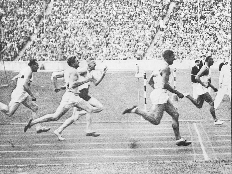 Jesse Owens wins the 100m at the 1936 Olympics in Berlin in equal world record time.