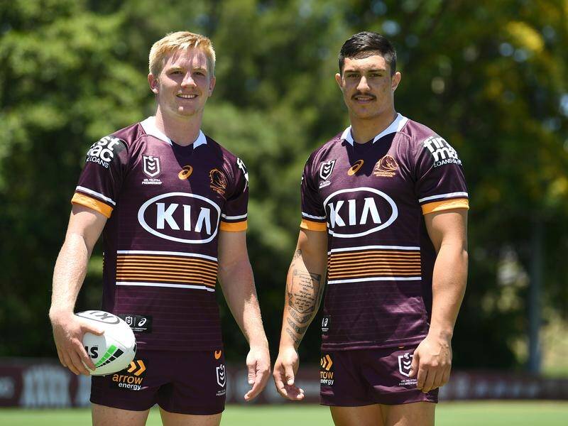 Tom Dearden (l) and Kotoni Staggs at Brisbane training in the Broncos' 2021 NRL season jersey.