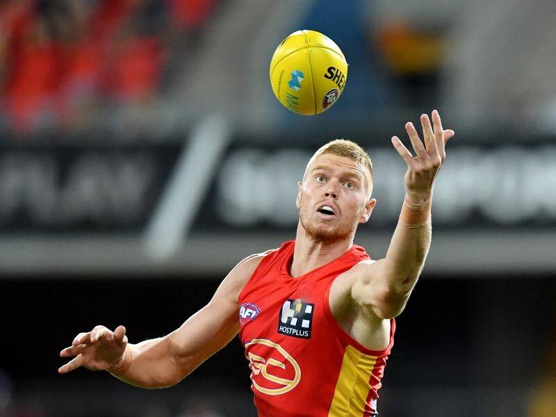 Peter Wright has signed with Essendon until the end of 2023 after an AFL trade with the Gold Coast.