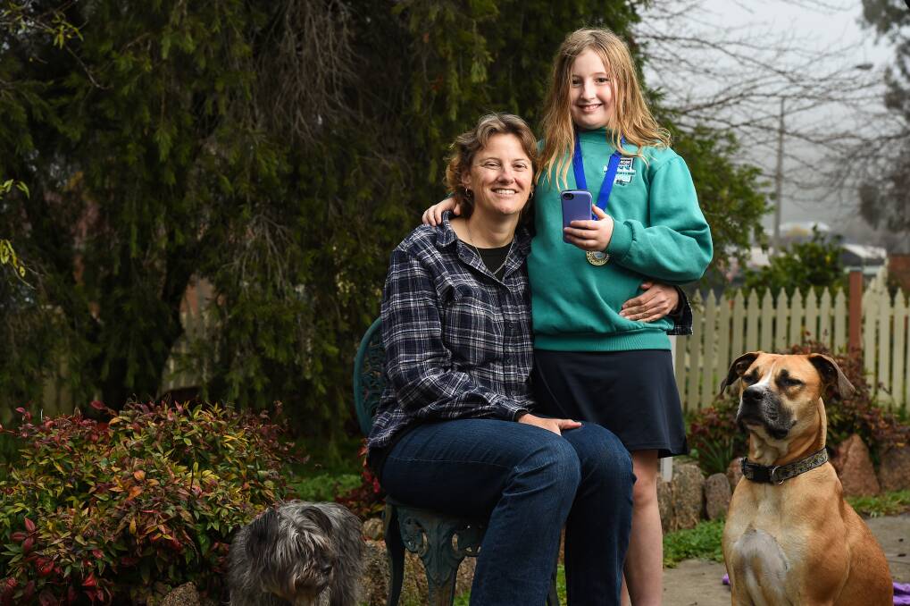 GREAT JOB: Amanda Dunn with her daughter Jess, 10, and dogs Lenny and Charlotte. Jess has been praised for saving her mum's life and being a Triple Zero Hero. Picture: MARK JESSER 
