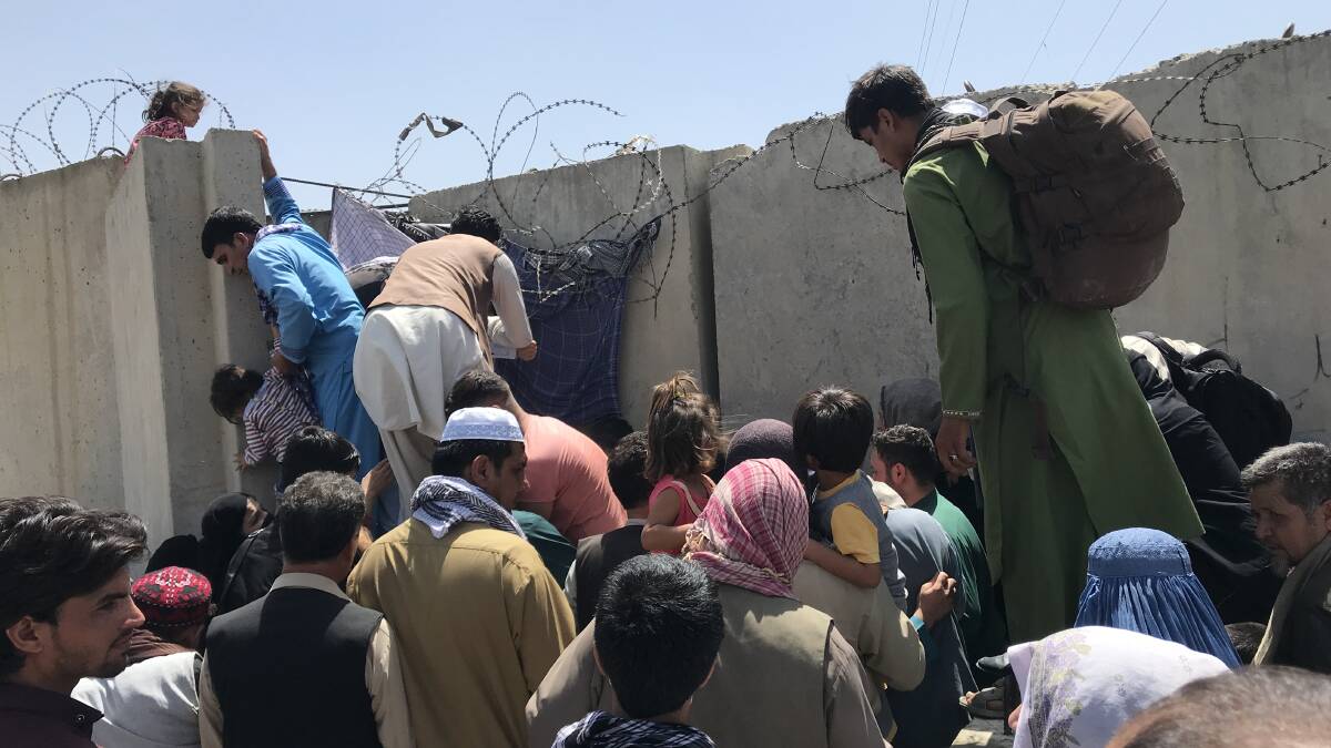 Families trying to enter Kabul's airport this week in an attempt to flee Afghanistan following the Taliban takeover. Picture: Getty Images