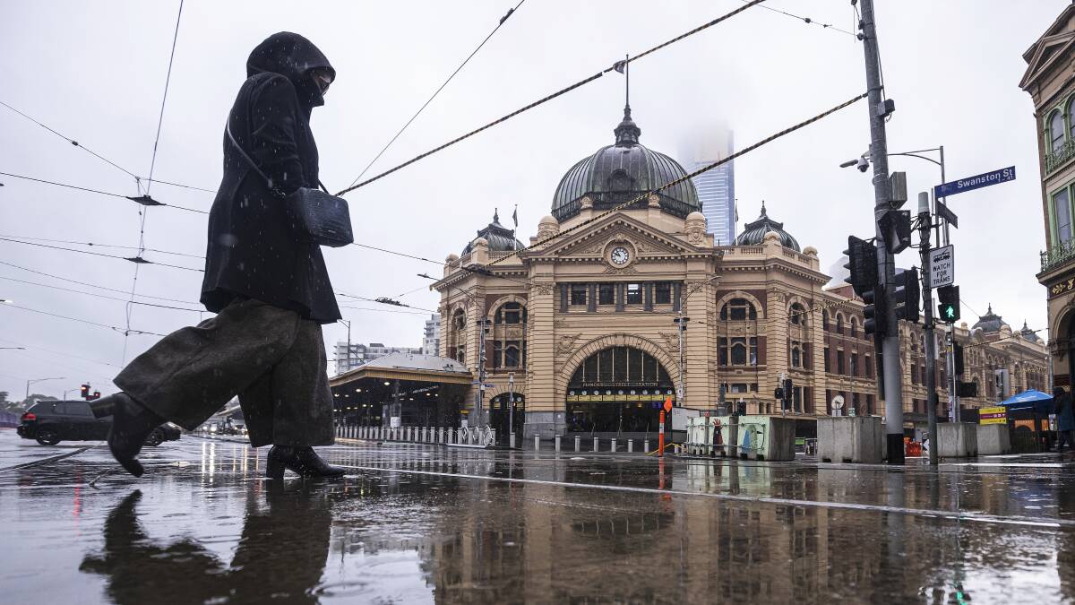 A pedestrian walks past Flinders Street Station in Melbourne on Friday as restrictions begin to ease. Picture: Getty Images