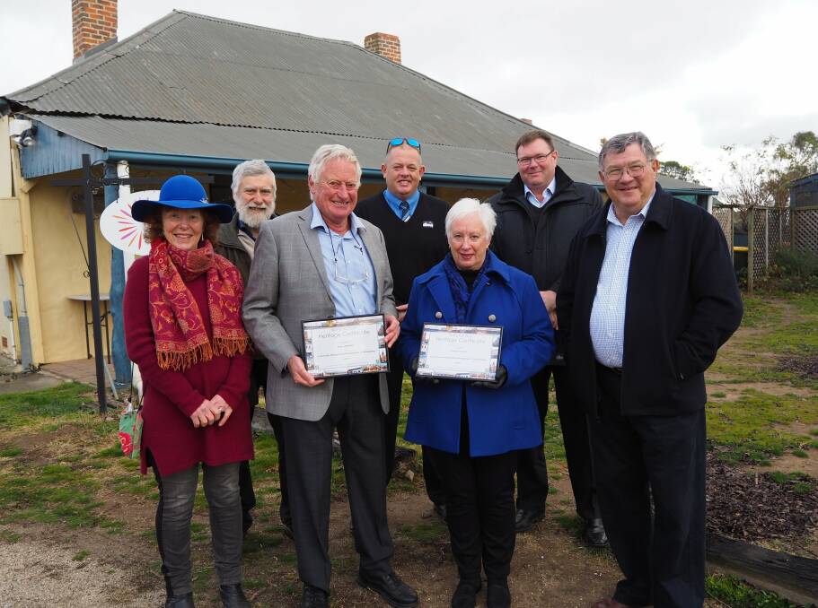 RESTORATION: O'Connell earth building workshop co-ordinator Angus McKibbin and Oberon mayor Kathy Sajowitz receive their National Trust Heritage Awards from Bathurst branch chairman Iain McPherson. Photo: SAM BOLT