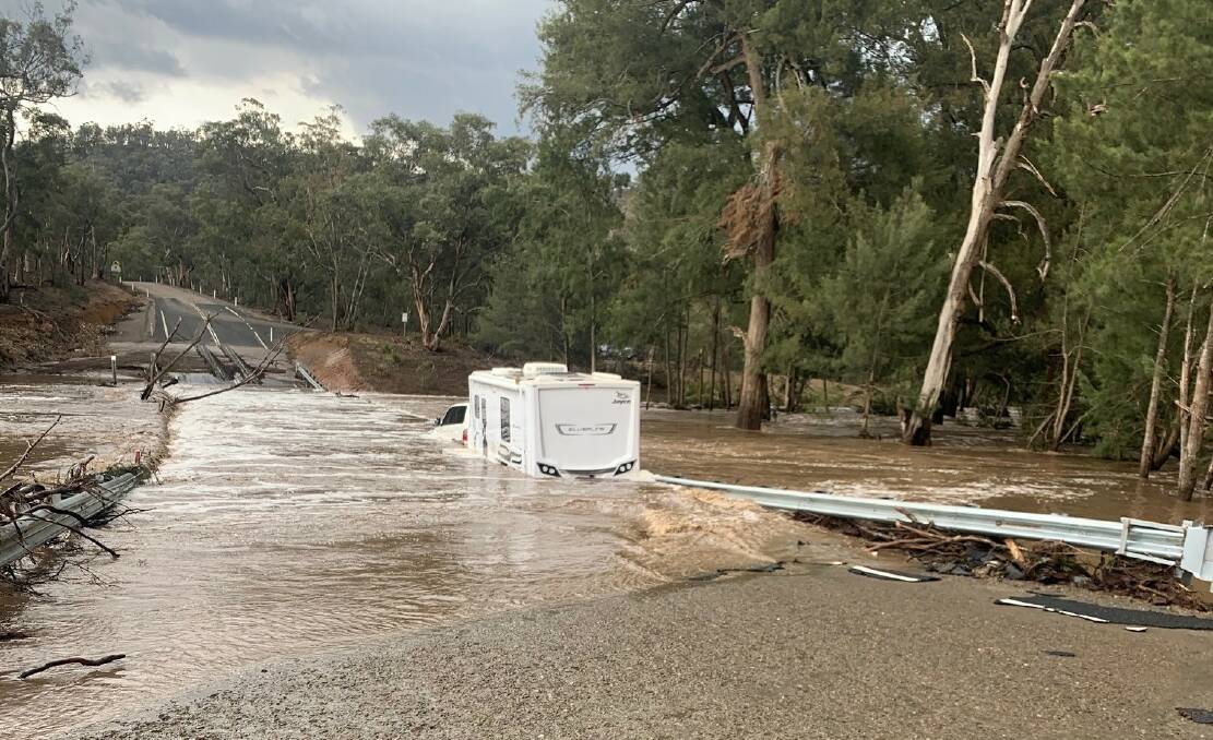 FLOODED: Two people had a very lucky escape after their car and caravan became stuck in floodwaters near Oberon. Photo: SUPPLIED