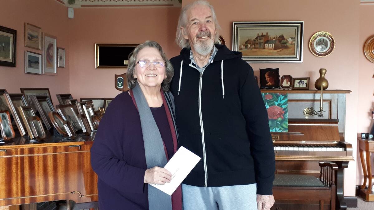 WINNERS: Local couple Inara and Ted Hawley receiving their prize, a Shop Local Voucher kindly donated by Oberon Business & Tourism Assoc (OBTA) for their beautiful photo. Photo: SUPPLIED