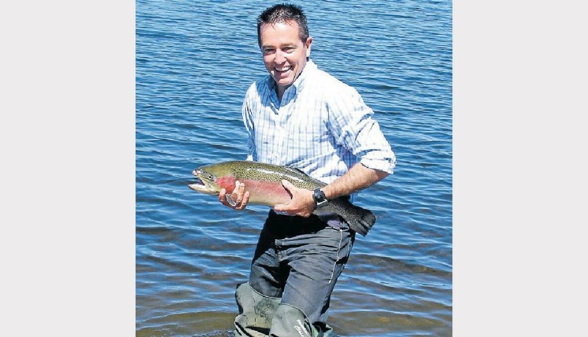 Member for Bathurst Paul Toole with one of the rainbow trout released into Lake Oberon.
